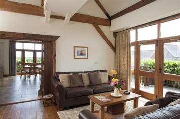 Open plan living area with doors through to decking area