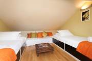 The twin bedroom is tucked away in the eaves of Lawn End, which is more suitable for older children due to the steep ladder and head restriction.