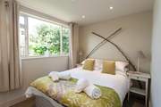 The second bedroom has a calm and relaxing decor.