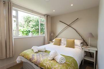 The second bedroom has a calm and relaxing decor.