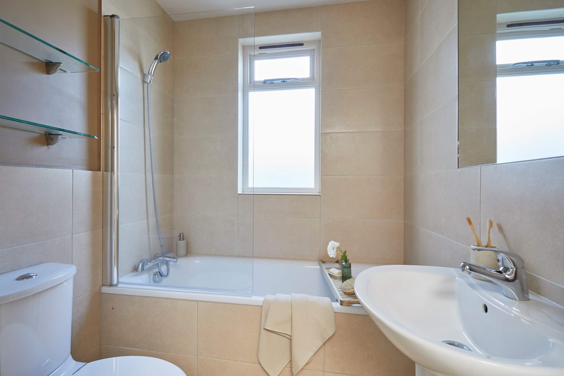 The family bathroom with bath and fitted shower.