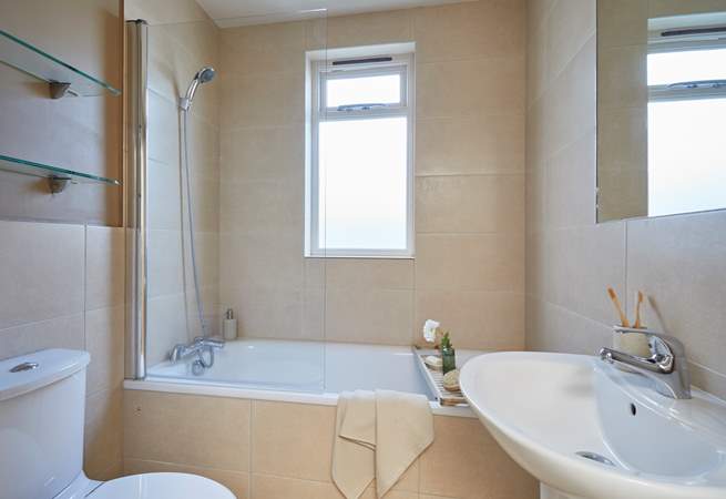 The family bathroom with bath and fitted shower.