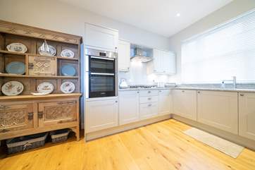 The lovely kitchen offers plenty of space and light.