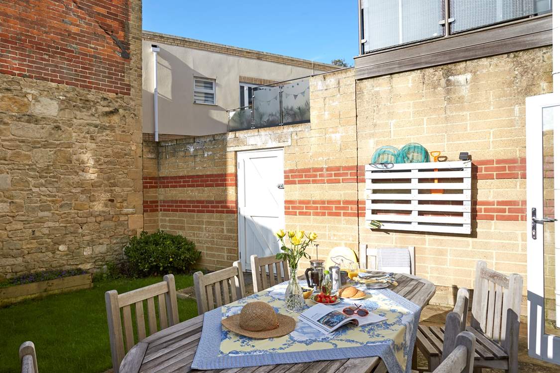Lovely patio garden with access gate to the private parking area.