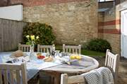 Great outdoor space for eating al-freso with sturdy quality patio furniture in the garden.