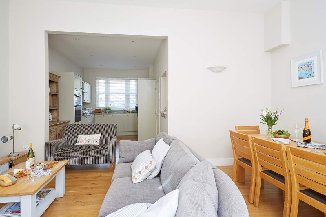 The open plan living-room, dining area and kitchen is perfectly proportioned for all guests to enjoy.