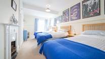 The third bedroom on the first floor with three single beds.