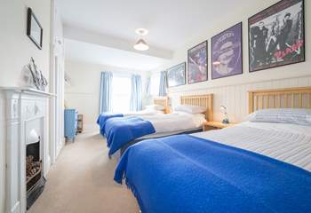 The third bedroom on the first floor with three single beds.