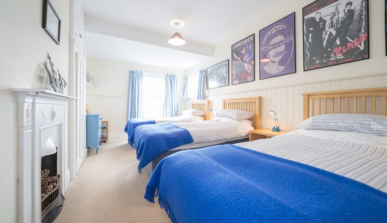 The third bedroom on the first floor with three single beds.