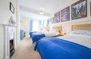 The third bedroom on the first floor with three single beds.