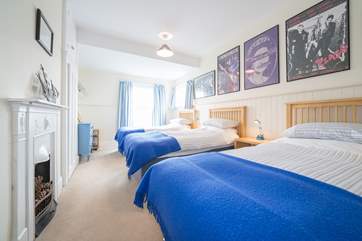 The third bedroom on the first floor with three single beds.