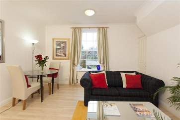The sitting/dining-room is light and spacious.