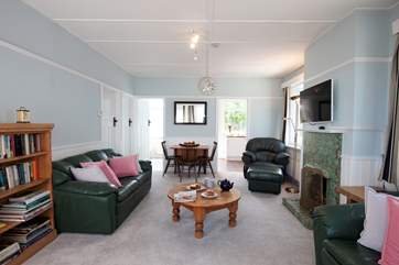 The bright sitting/dining-room has plenty of comfortable seating.