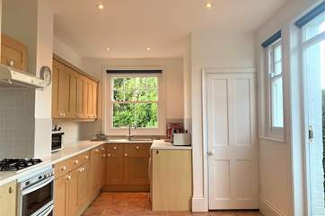 The open plan kitchen and dining area has a door out to the rear enclosed garden.