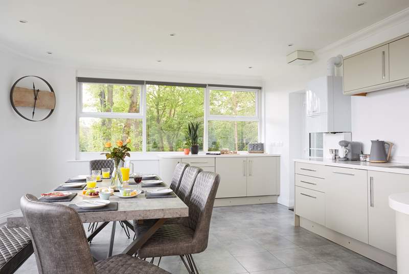 Enjoy preparing a meal in the modern kitchen with dining area.