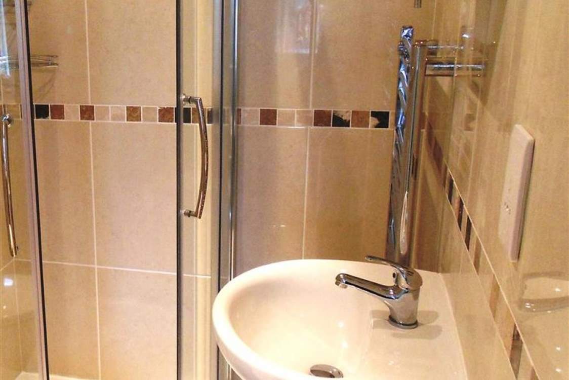 This shower-room has a large shower cubicle.