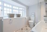 The stunning family bathroom with bath and shower over