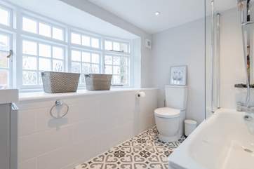 The stunning family bathroom with bath and shower over