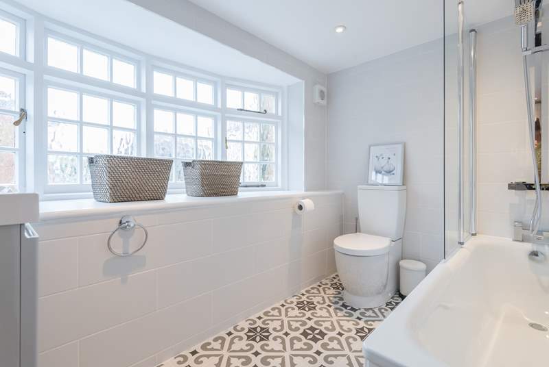 The stunning family bathroom with bath and shower over