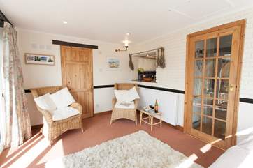 The sunny conservatory looks out to the cottage
garden.