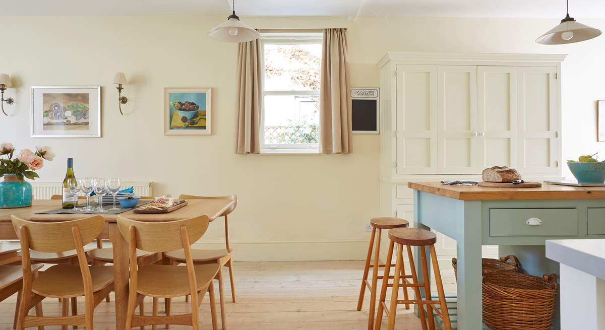 Light and airy kitchen with stylish dining-table and chairs.