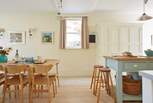 Light and airy kitchen with stylish dining table and chairs.