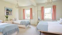 The large family bedroom with twin beds and a king-size bed, ideal for a young family.