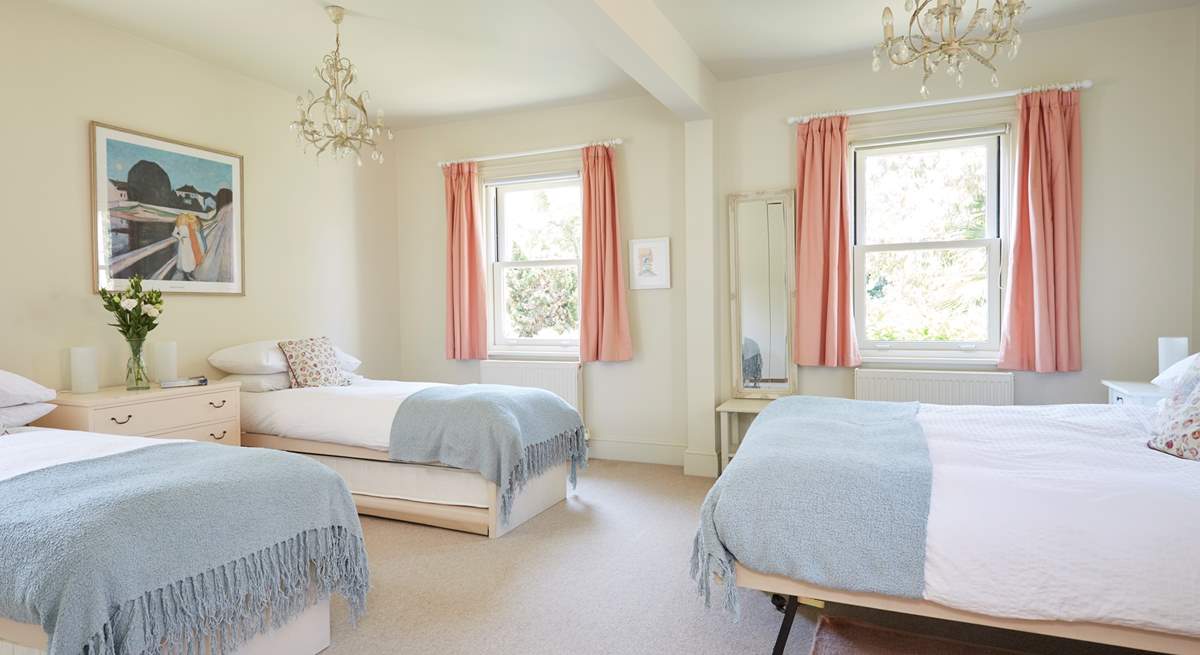 The large family bedroom with twin beds and a king-size bed, ideal for a young family.