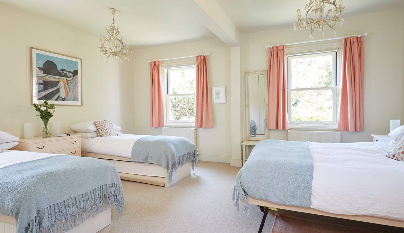 The large family bedroom with twin beds and a king-size bed, ideal for a young family.