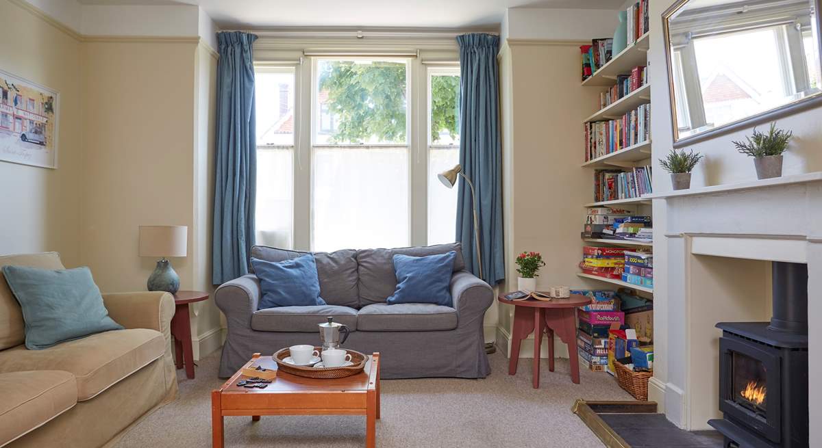 The family room with comfortable sofas and a wood-burner effect gas stove.