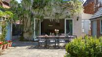 The gorgeous wisteria drapes the back of Orchard House when in bloom.