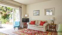 The sitting-room with open bi-fold doors bringing the outside in.