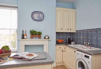 The bright and airy kitchen with all the modern appliances.