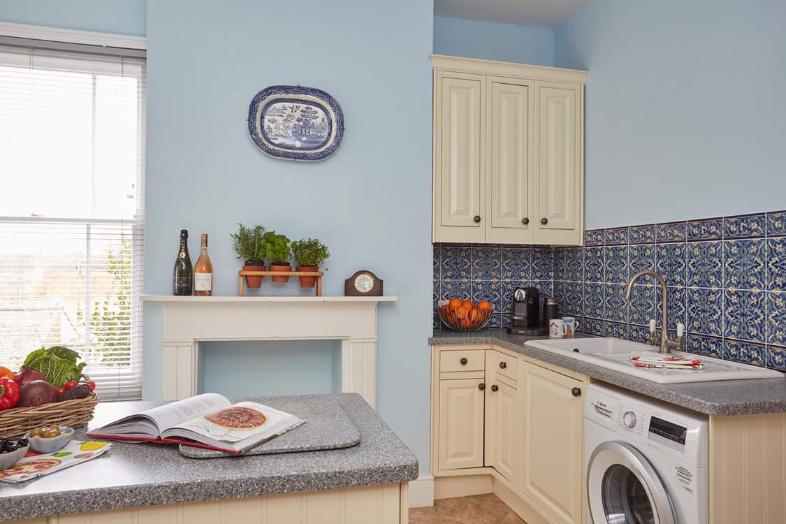 The bright and airy kitchen has modern appliances.