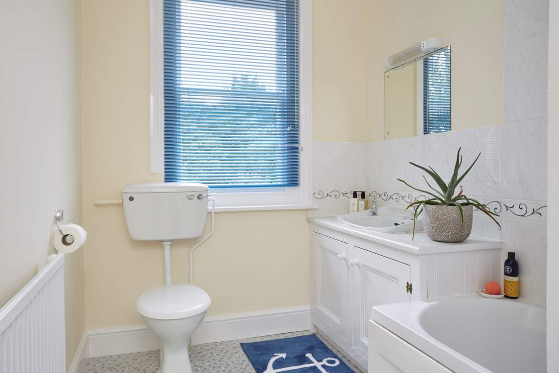 The fresh white bathroom suite.