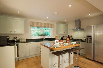 The sytlish kitchen with island and breakfast bar is an ideal space to prepare your favourite meals.