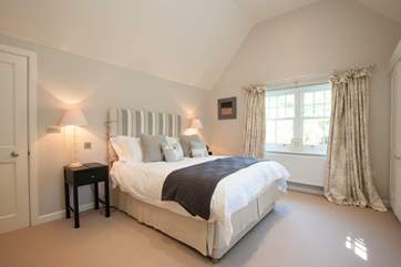 The impressive master bedroom has views out to the front garden.