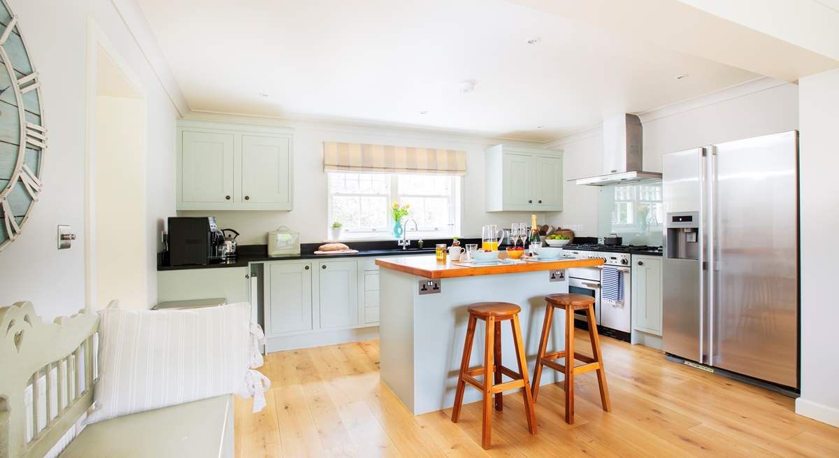 The sytlish kitchen with island and breakfast bar is an ideal space to prepare your favourite meals.