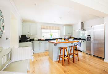 The sytlish kitchen with island and breakfast bar is an ideal space to prepare your favourite meals.