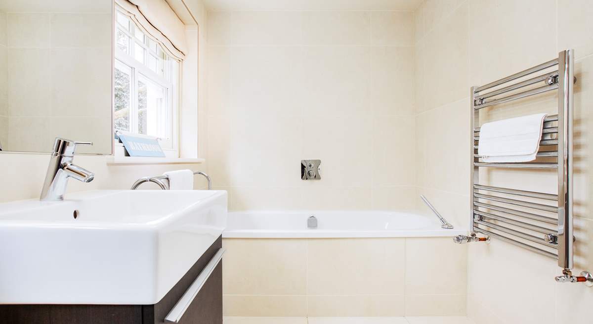 The family bathroom with a luxurious bath to soak in and relax.