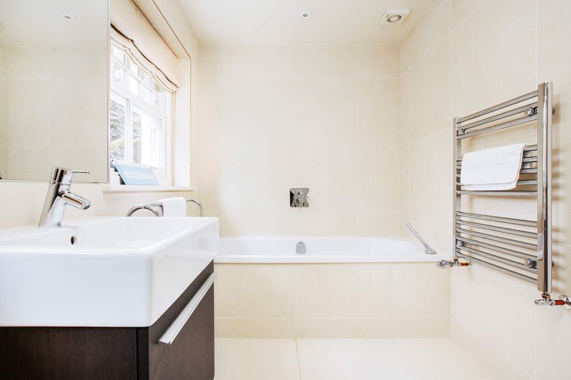 The family bathroom with a luxurious bath to soak in and relax.
