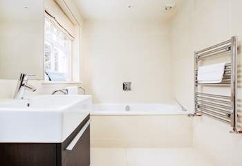 The family bathroom with a luxurious bath to soak in and relax.