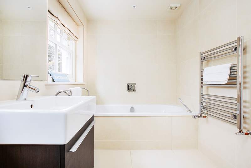 The family bathroom with a luxurious bath to soak in and relax.