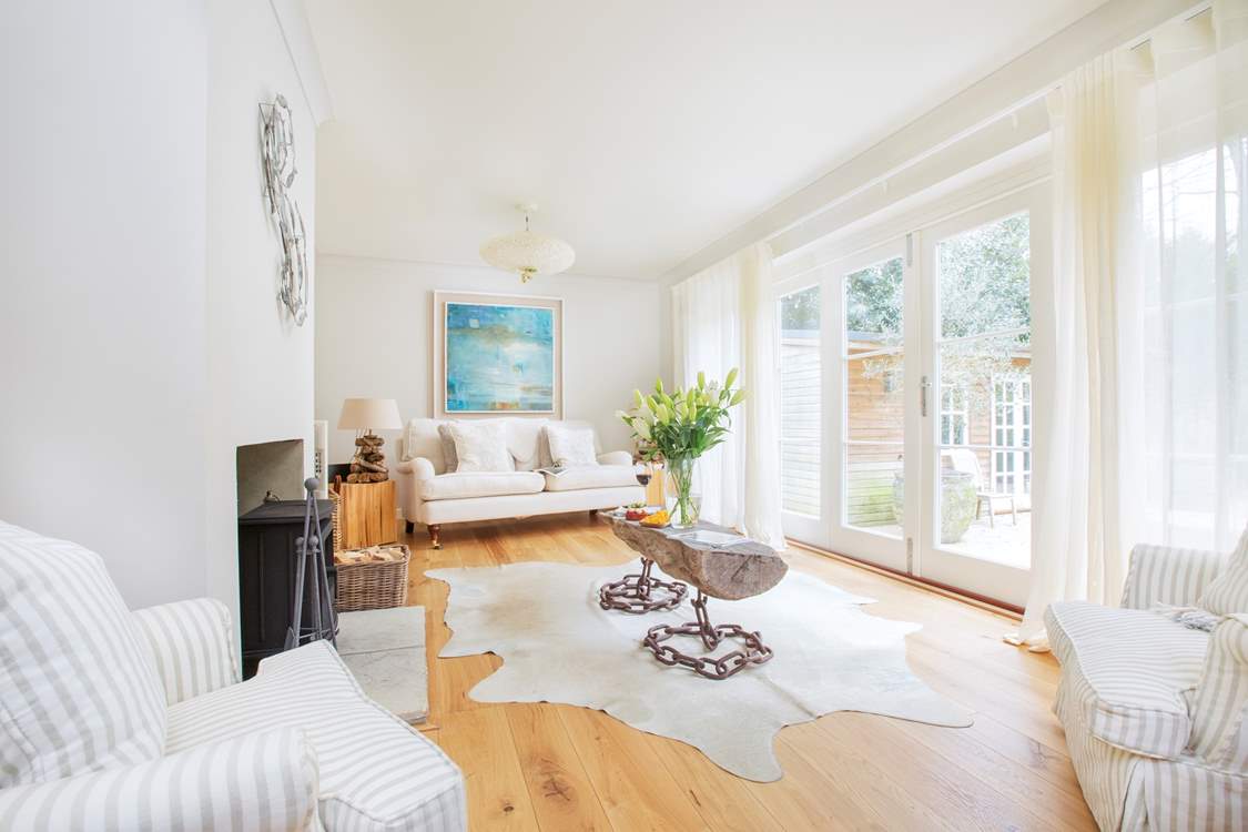 The second sitting room has doors leading out to the al fresco dining area and the games room.