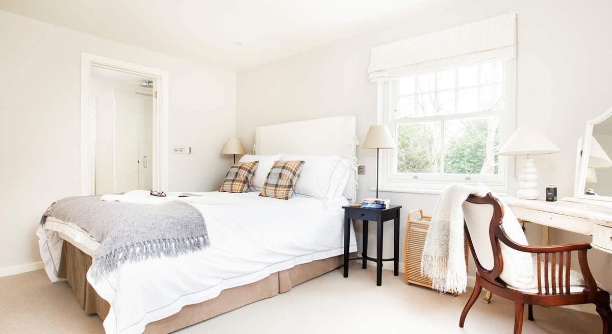 The en suite corner bedroom at the top of the stairs overlooks the front garden and the side patio. 