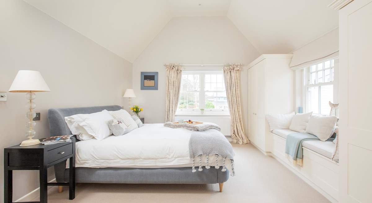 The impressive master bedroom with super-king size bed has views out to the front garden.   