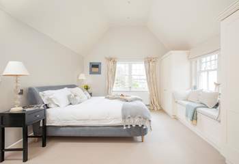 The impressive master bedroom with super-king size bed has views out to the front garden.   