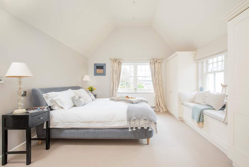 The impressive master bedroom with super-king size bed has views out to the front garden.   
