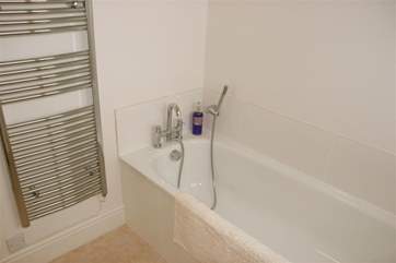 Family bathroom with heated towel rail.