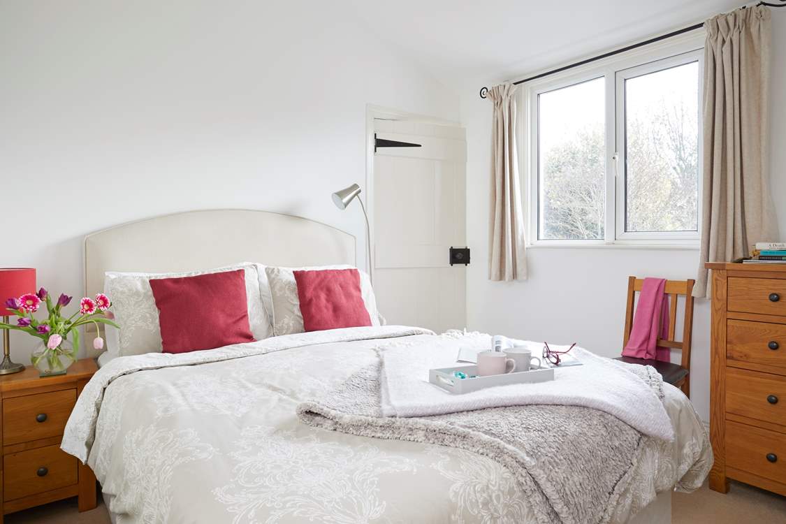 Bright and spacious, the main bedroom with ensuite shower room.